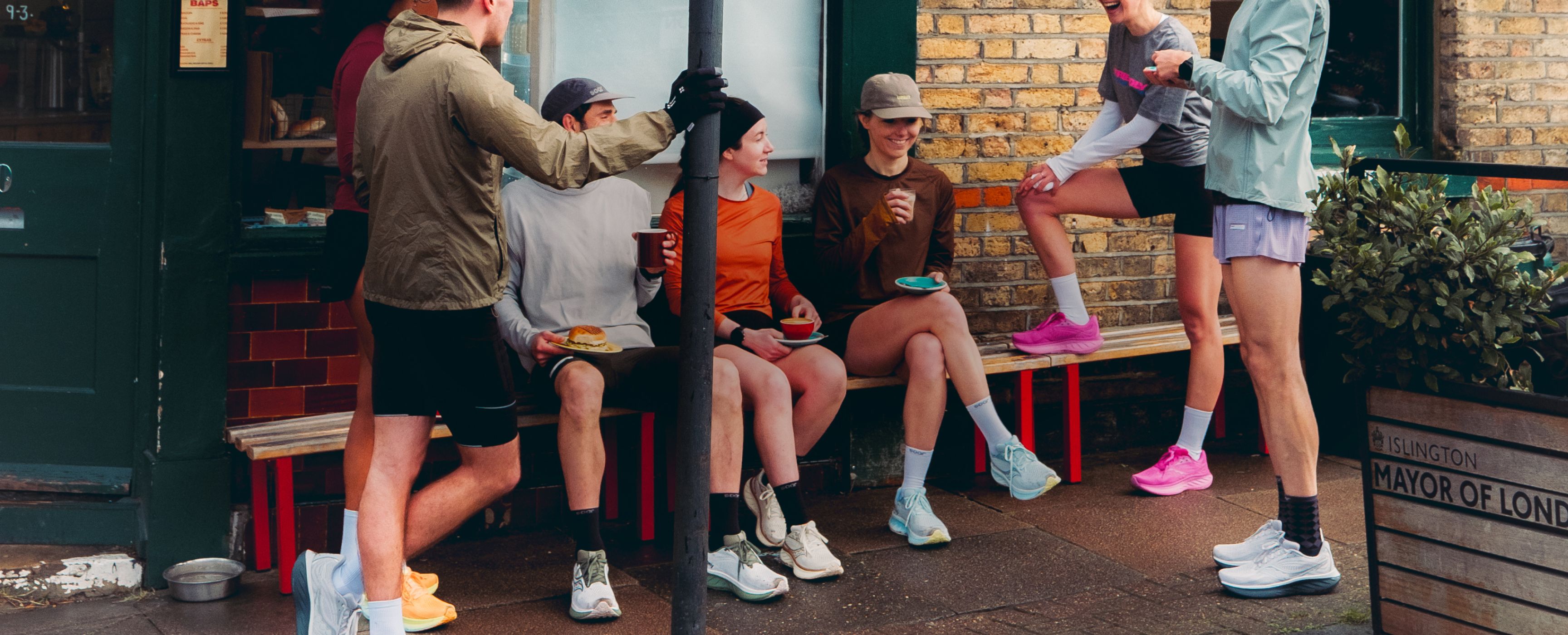 a group of people sitting on a bench outside a building
